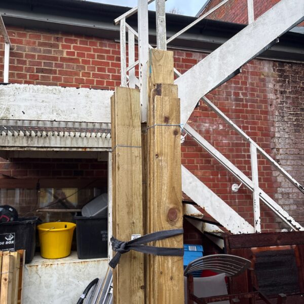 Three bundles of timber stored outdoors, ready for DIY projects.