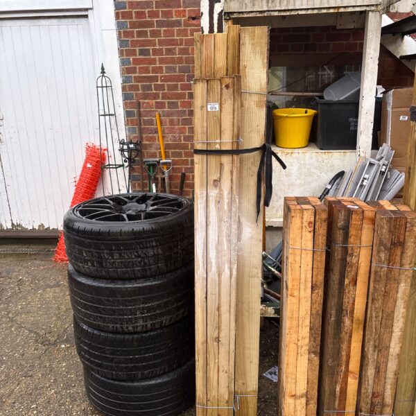 Stacked timber bundles for garden and DIY projects.