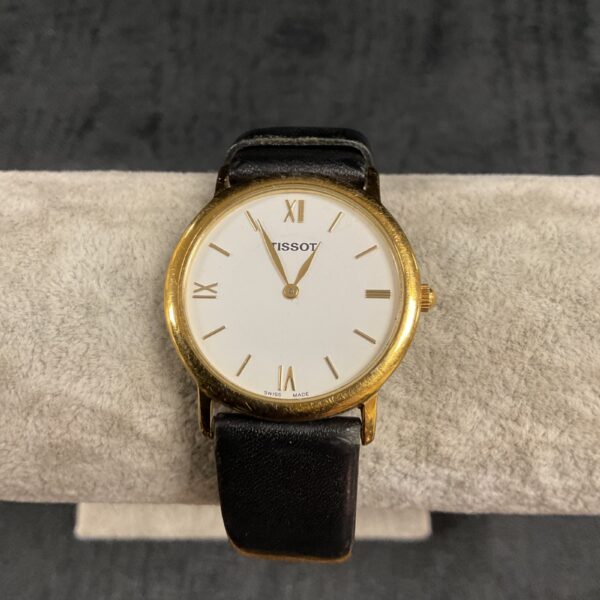 Vintage Tissot quartz wristwatch with Roman numeral dial.
