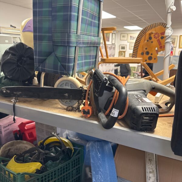 Used Titan electric chainsaw with chain needing attention.