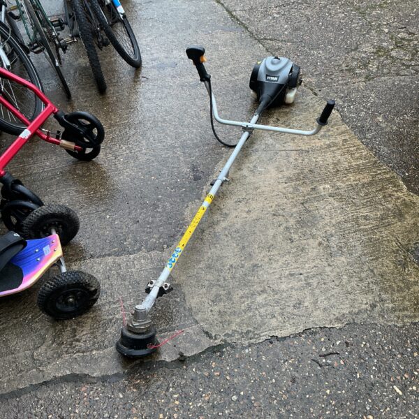 Titan petrol garden strimmer for maintaining lawns and gardens.