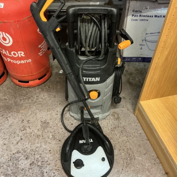 Used Titan power washer with patio cleaning head attachment for garden cleaning.