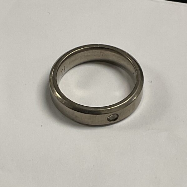 Sleek titanium ring with a white stone V set design.