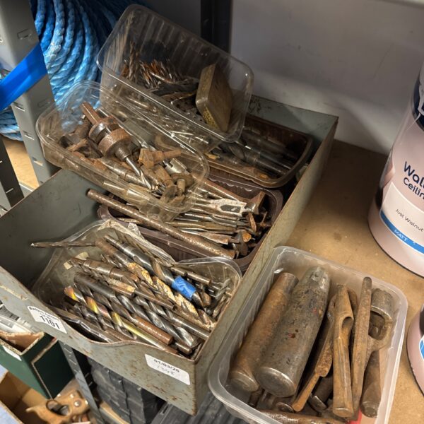 Assorted drill bits and punches in a tool lot.
