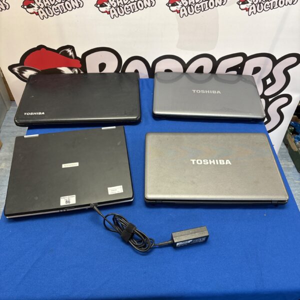 Toshiba laptop bundle showing four laptops on a blue table.
