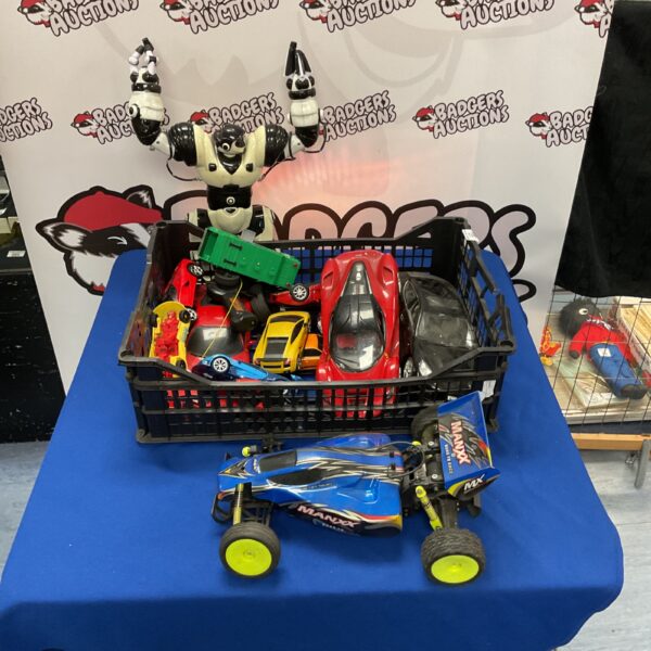 Crate of assorted toy cars and a RoboSapien robot.