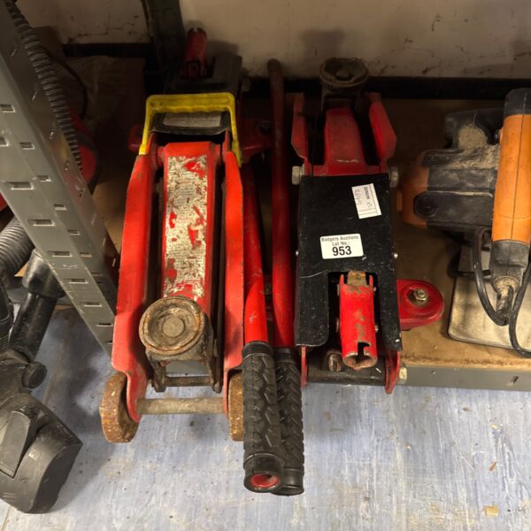 Pair of used trolley jacks for automotive repair.
