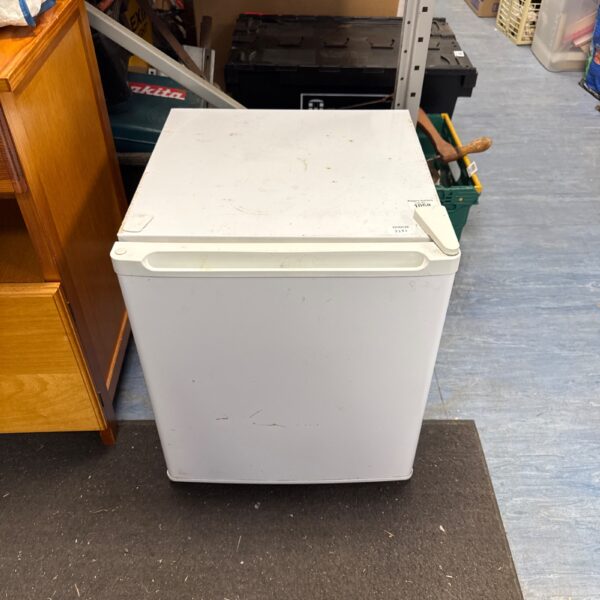 Small white under counter freezer for kitchen storage.