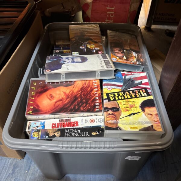 VHS movie tape lot in a plastic container.