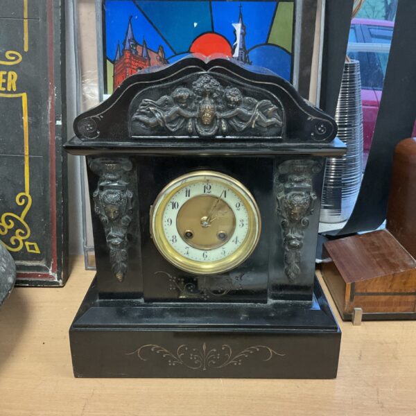 Ornate Victorian French slate mantle clock with Roman numeral face.