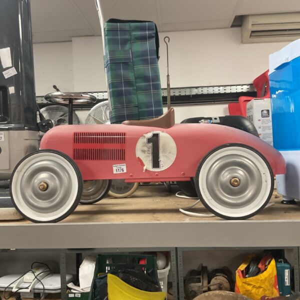 Pink metal Vilac ride-on car, vintage children's toy.