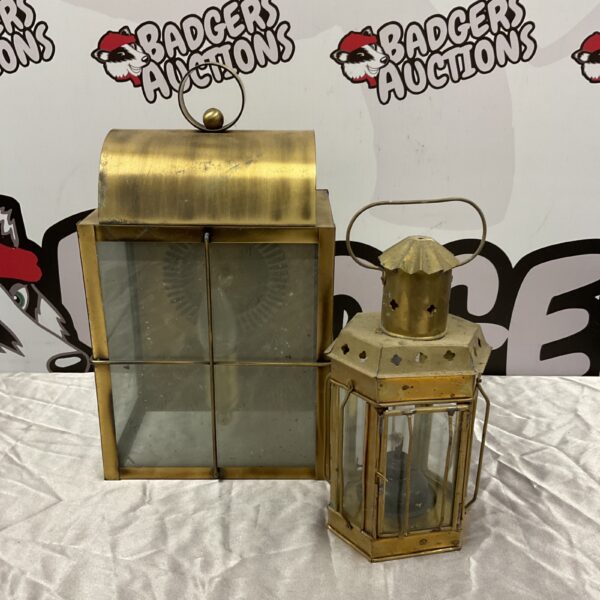 Vintage brass lantern with glass panels, ideal for wall mounting.