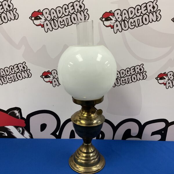 Vintage brass oil lamp with glass shade for antique lighting.