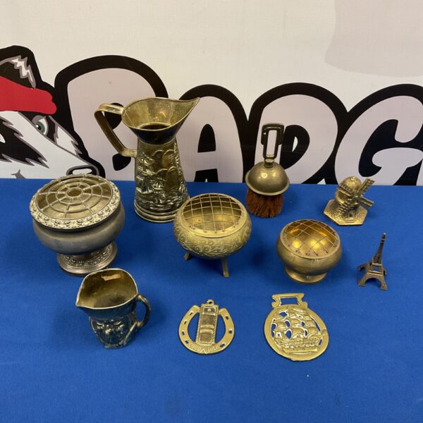Vintage brassware collection featuring a jug, rose bowl, and horse brasses.