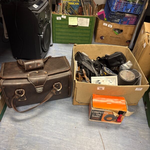 Vintage camera accessories lot with cases and equipment.