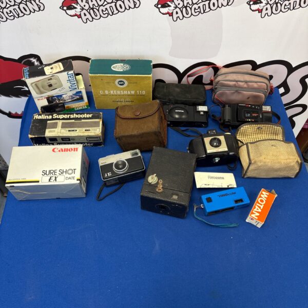 Vintage camera lot featuring a Canon Sure Shot and other retro models.