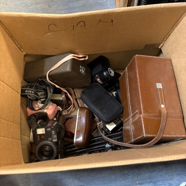 Mixed lot of vintage film cameras and photography equipment.