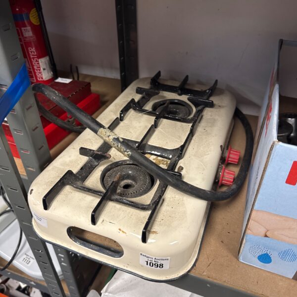 Vintage enamel twin burner camping stove for outdoor cooking.