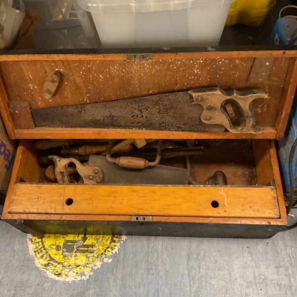 Vintage carpenter's tool chest filled with antique woodworking tools.