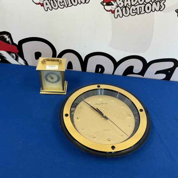 Gold vintage carriage clock with clear plastic front.