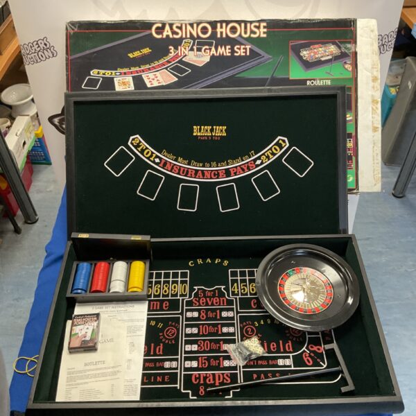 Vintage casino game set with Roulette, dice, and cards.