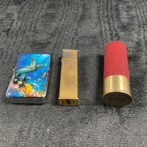 Vintage cigarette lighters including Dunhill and shotgun shell design.