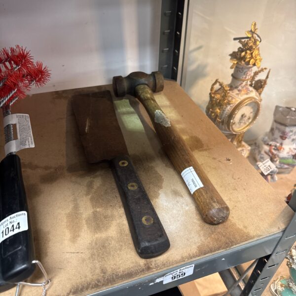 Vintage cleaver hammer with wooden handle, antique metalworking tool.