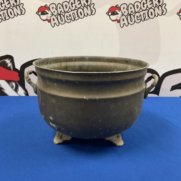 Vintage copper pot with handles and feet.