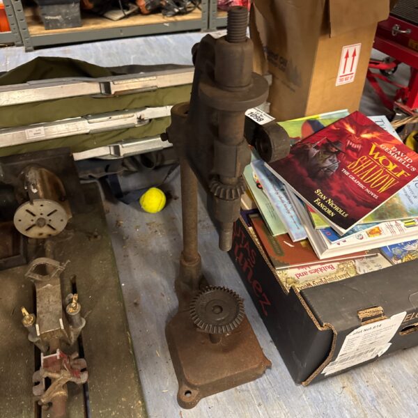 Vintage drill press stand with signs of age and wear.