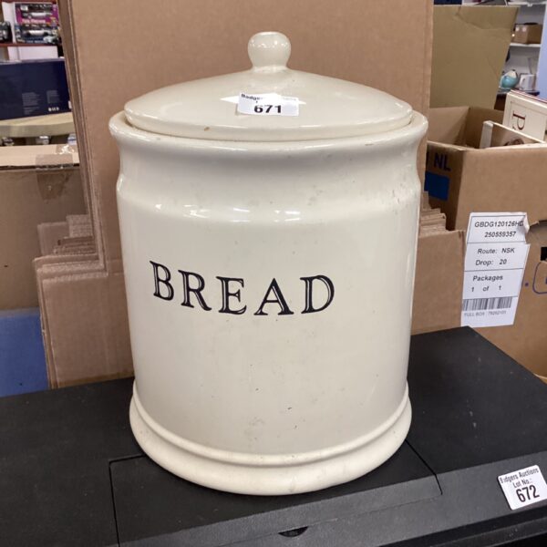 White vintage enamelled bread bin for kitchen storage.