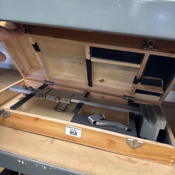 Vintage engineers height gauge set in wooden case for precision measurement.