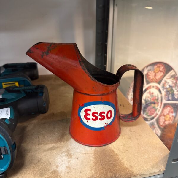 Vintage Esso oil can with red paint and logo.