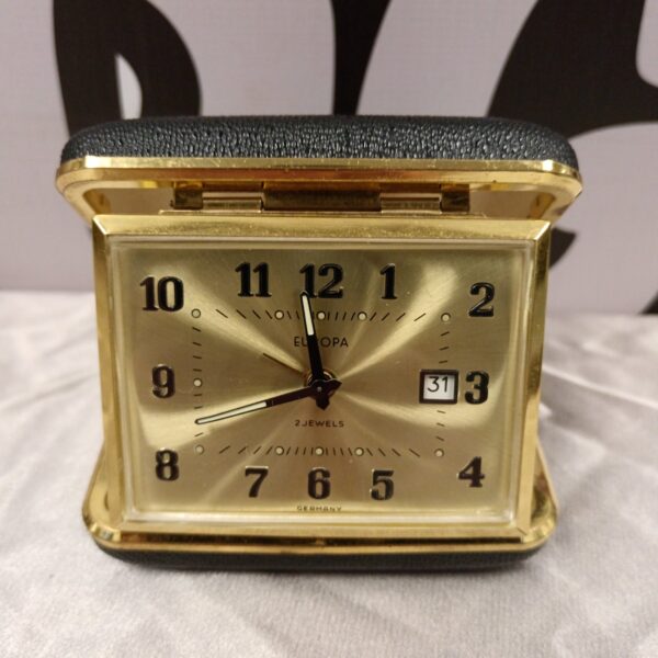 Vintage Europa travel clock with brass case and Roman numerals.
