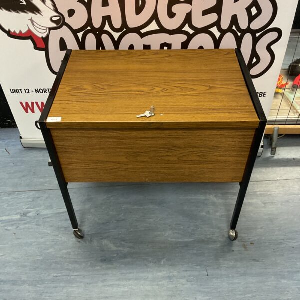 Vintage metal filing cabinet with wood grain finish.