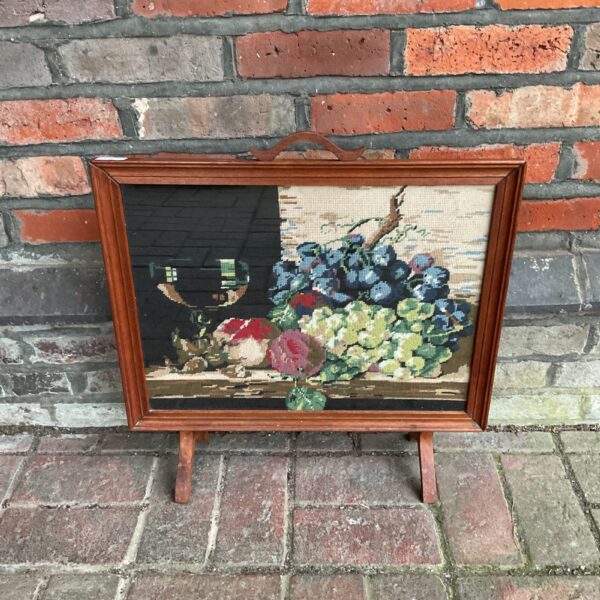 Vintage fire guard tapestry with floral design and oak frame.