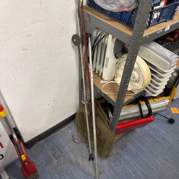 Vintage fishing nets and rod stands, angling equipment collection.