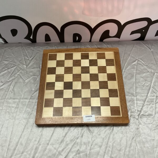 Vintage wooden folding chess set with pieces displayed.