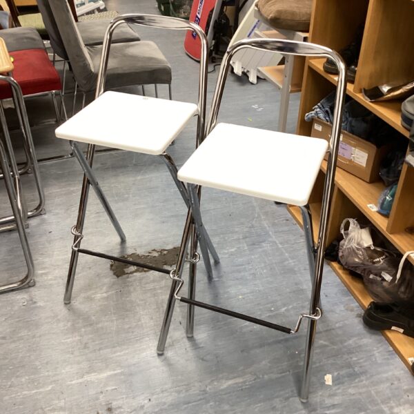 Vintage white folding kitchen stools with chrome frames.