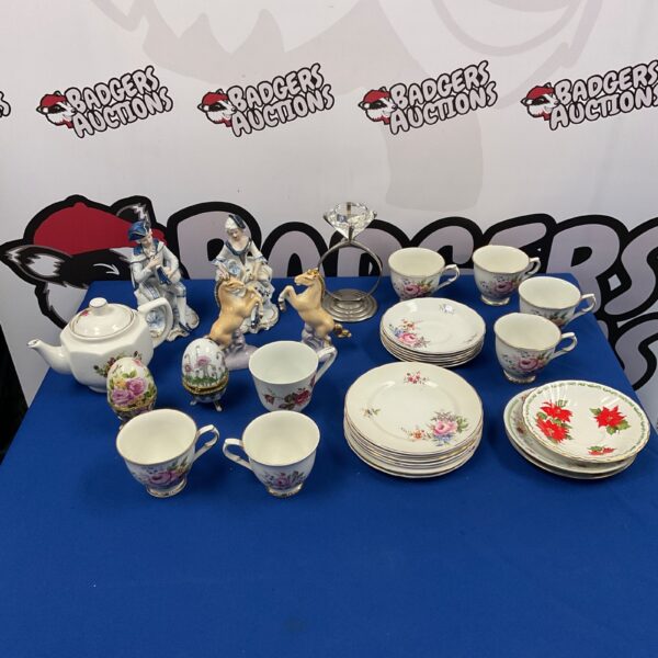 Vintage Foley China tea set with floral patterns on display.