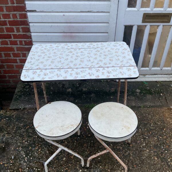 Vintage formica kitchen table set with patterned top and metal legs.