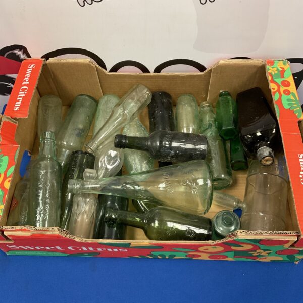 Collection of vintage glass bottles, antique glassware, collectible items.