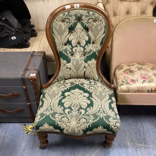Vintage green balloon back chair with casters.