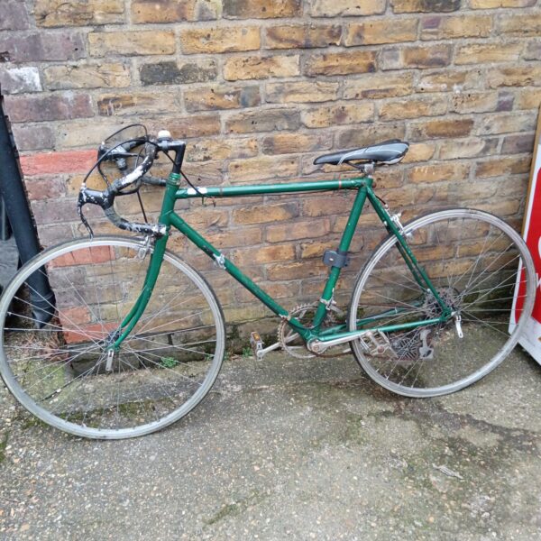 Vintage green racer bike in used condition.