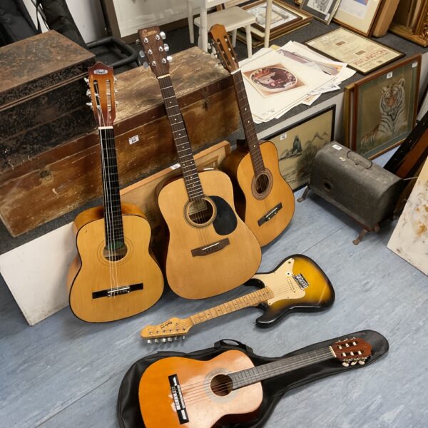Vintage guitar lot featuring acoustic and electric instruments.