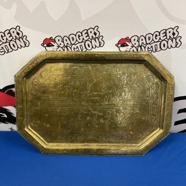 Intricate vintage Indian brass tray with embossed floral design.