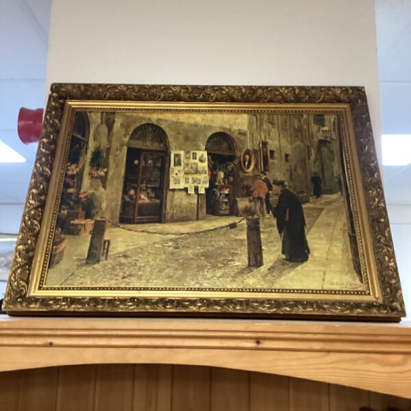 Ornate gilt frame surrounding a vintage Italian street scene print.
