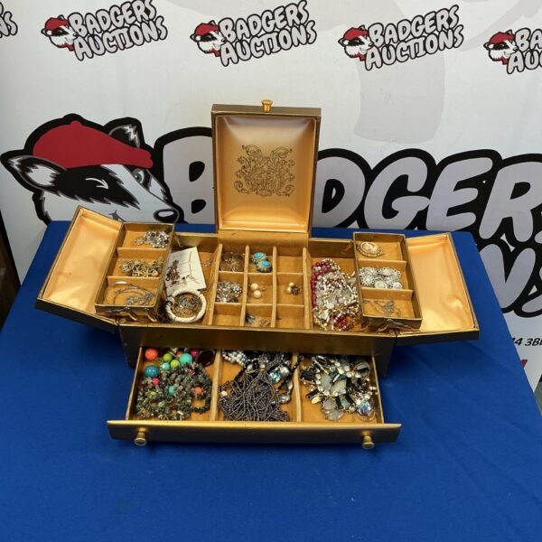 Vintage jewellery box filled with assorted necklaces, bracelets, and beaded jewellery.