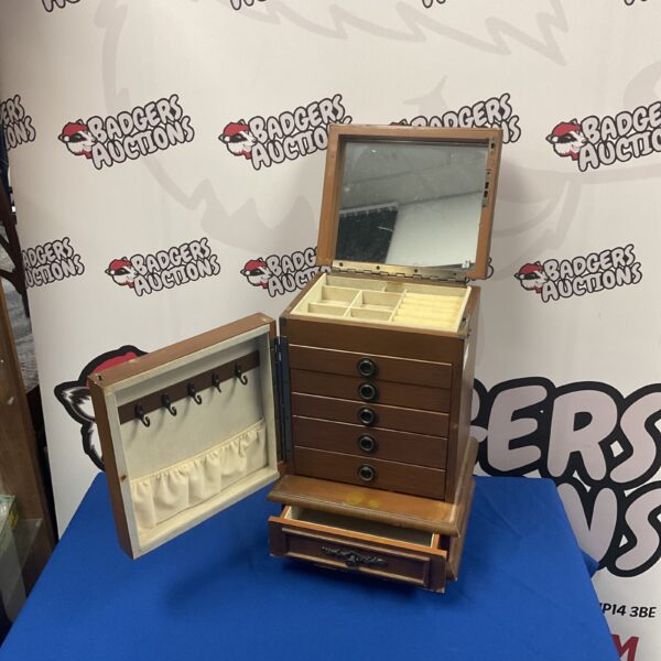 Vintage wooden jewellery cabinet with seven drawers and a mirror.
