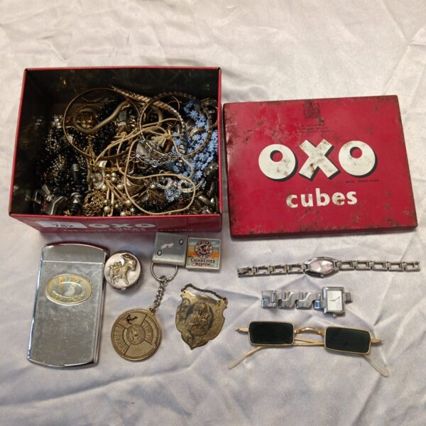 Vintage jewellery and watches inside an original Oxo tin.
