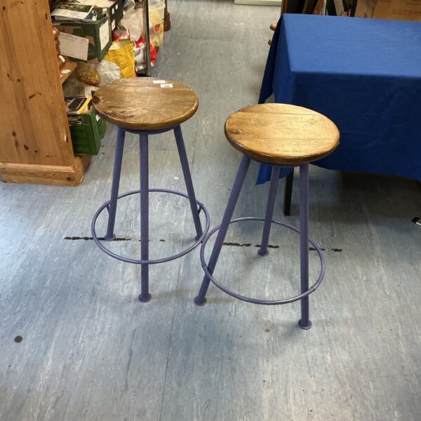 Pair of vintage blue lab stools with wooden seats.